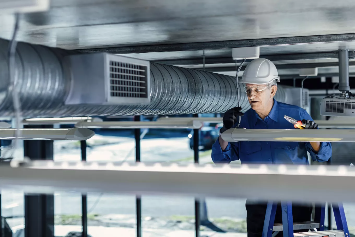 Man servicing air conditioning unit